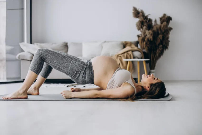 Pregnant woman performing prenatal yoga to prevent tailbone pain during pregnancy