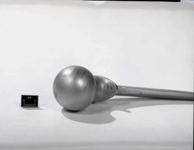 Metal femoral head component of a hip prosthesis used in total hip arthroplasty (THA)